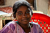 The great Chola temples of Tamil Nadu - The Sri Ranganatha Temple of Srirangam. Young girl selling votive lamps to the pilgrims. 